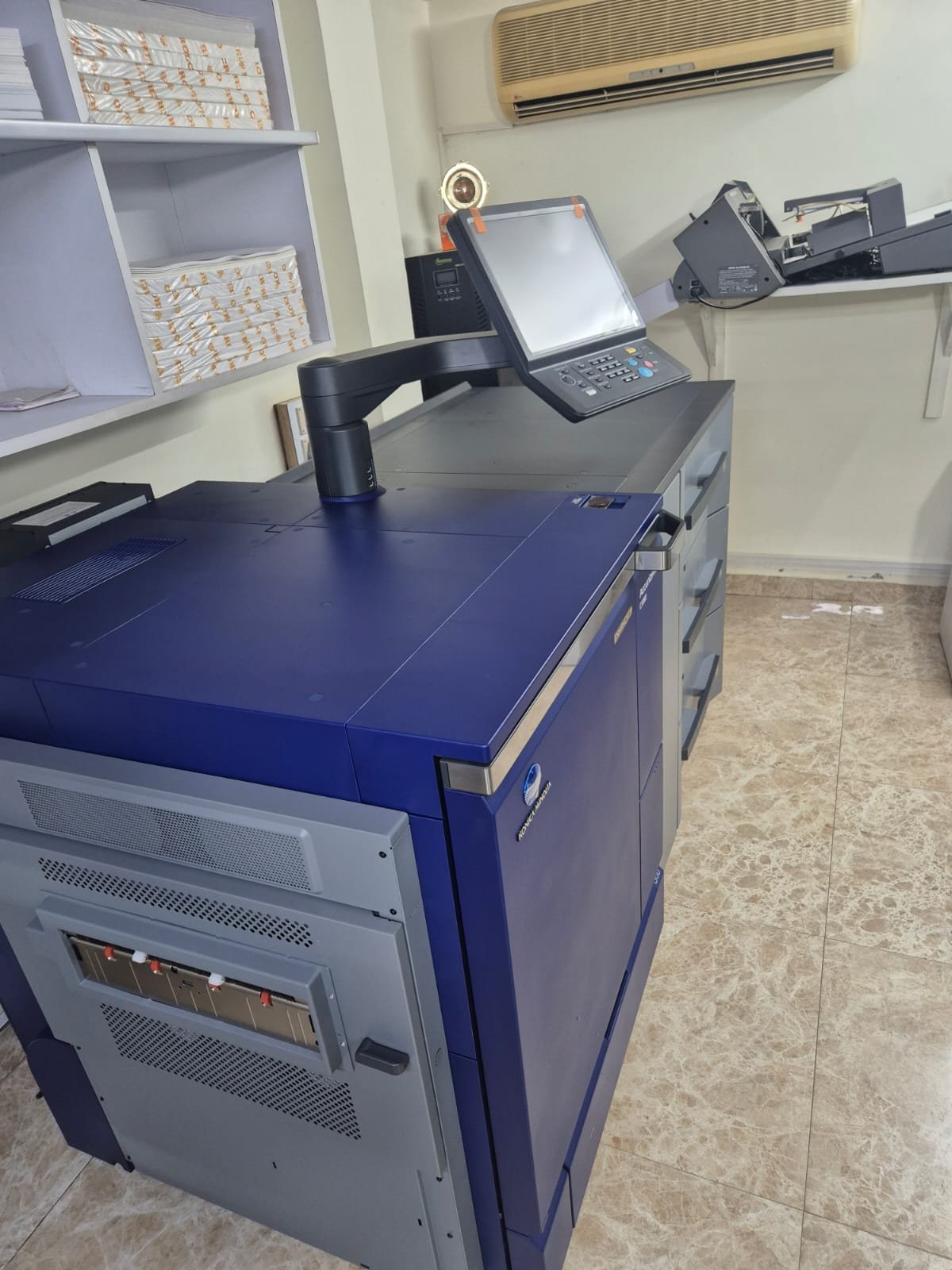 AccurioPress C7090 finishing unit, angled view